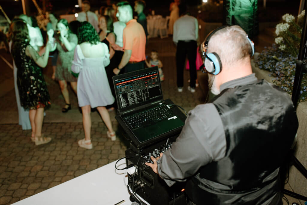 DJ at mixer with people dancing